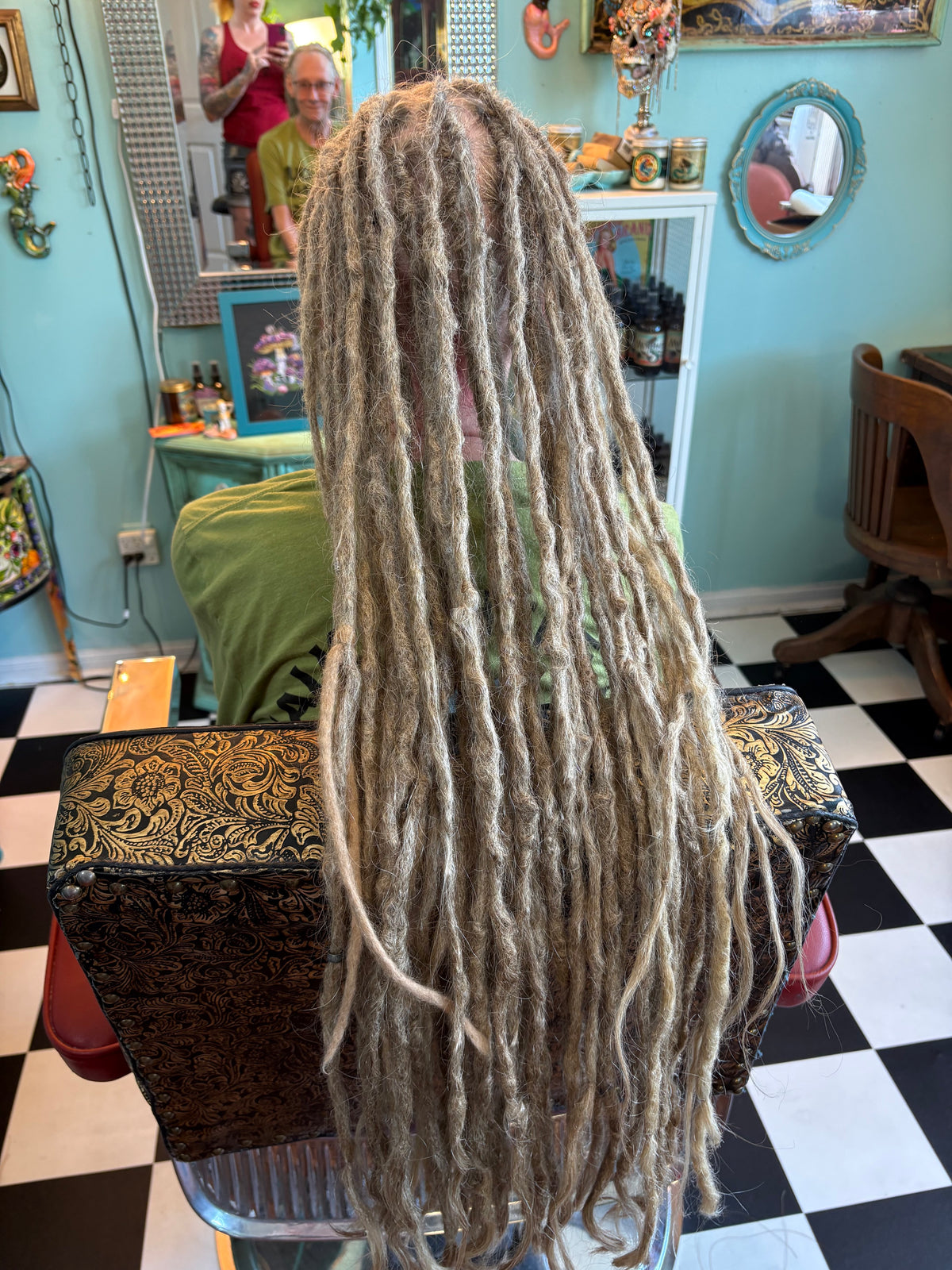 Back view of a Josie, Krista's client with long, grey locs at Dread Love Studio.