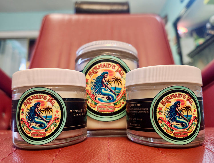 Three jars of Dread Love's natural dread wax displayed on red salon chair - waxes in 2 oz glass jars