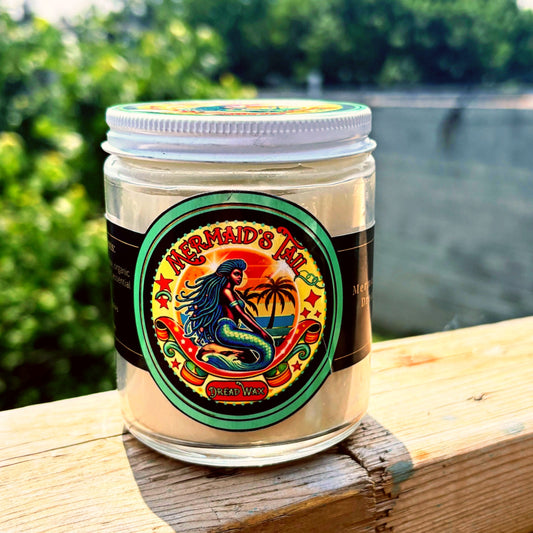 Jar of 'Mermaid's Tail' Dread Wax with a colorful label on a wooden surface outdoors.