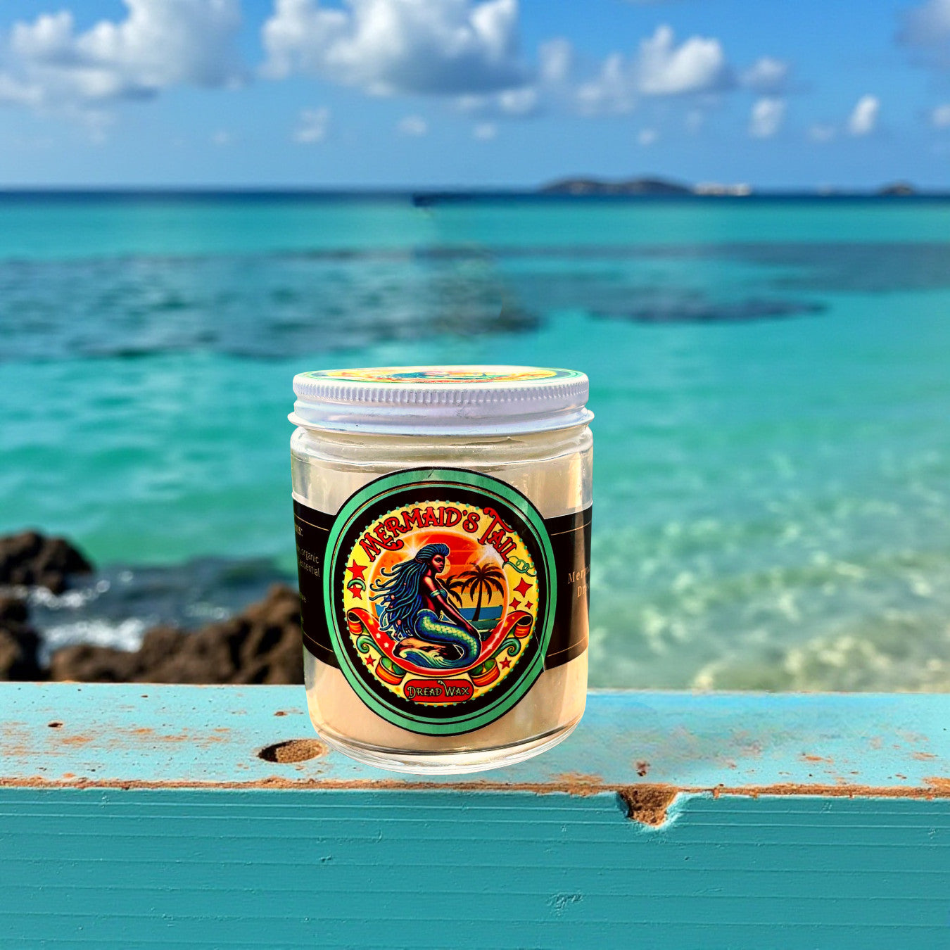 Jar of dread wax with a mermaid label on a wooden surface with ocean in the background