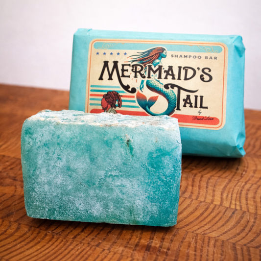 Clarifying shampoo, turquoise shampoo bar on a wooden surface with packaging in the background