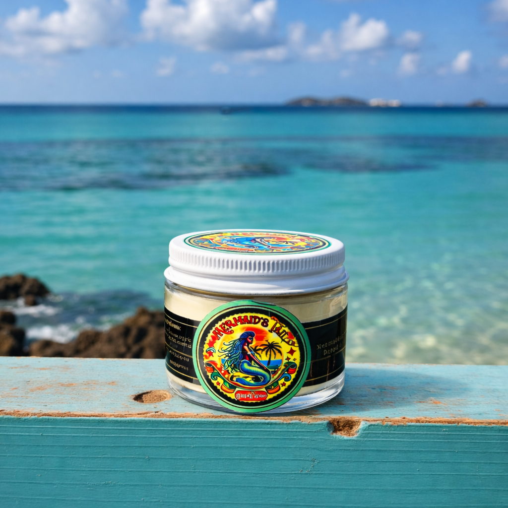 Small Jar of Mermaid's Tail dread wax with a tropical design on a wooden surface with ocean view