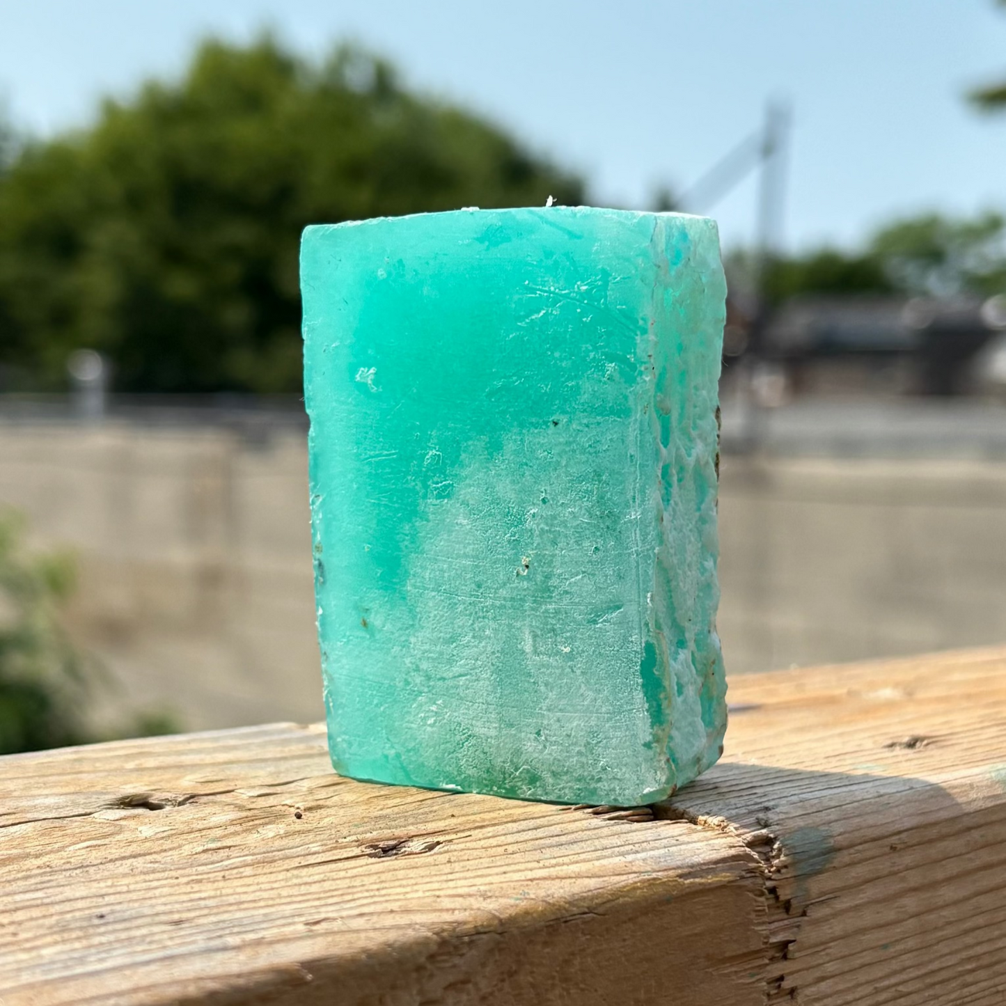 Unwrapped Glycerin Shampoo Bar by Dread Love on backyard railing — residue-free care for sensitive scalps, dreadlocks and natural hair