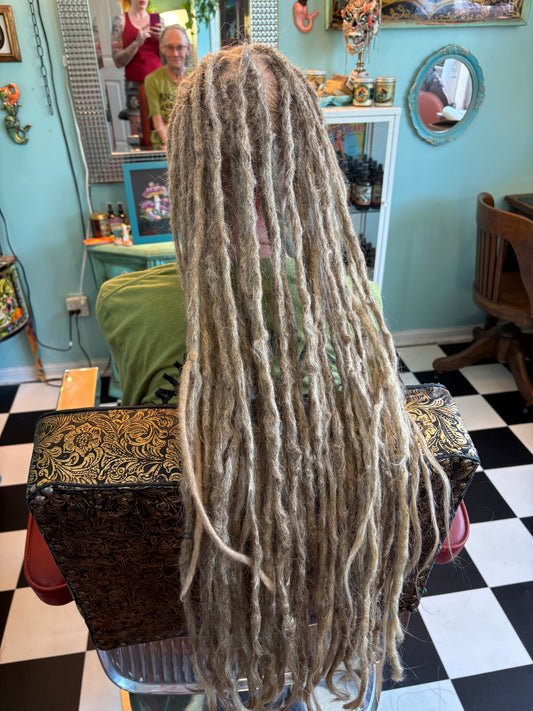 Back view of a Josie, Krista's client with long, grey locs at Dread Love Studio.